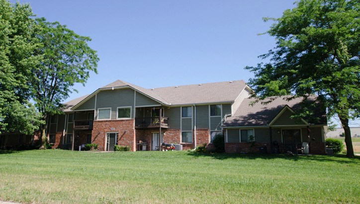 a large lawn in front of an apartment building