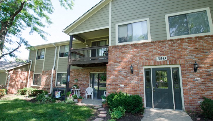 the front of a house with a porch and a door