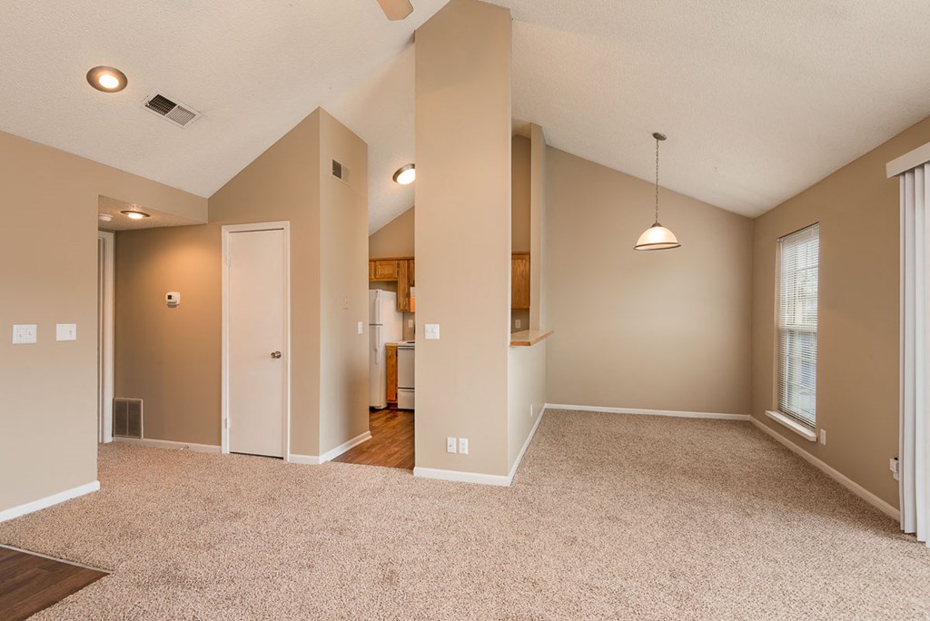 the spacious living room and dining room in a new home