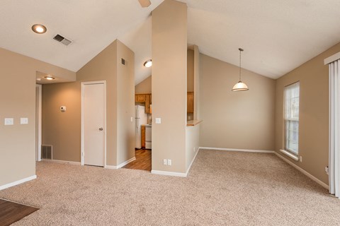 the spacious living room and dining room in a new home