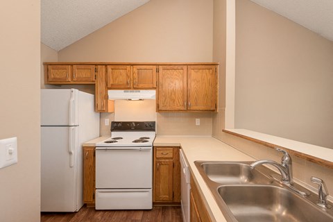 a kitchen with a stove refrigerator and sink