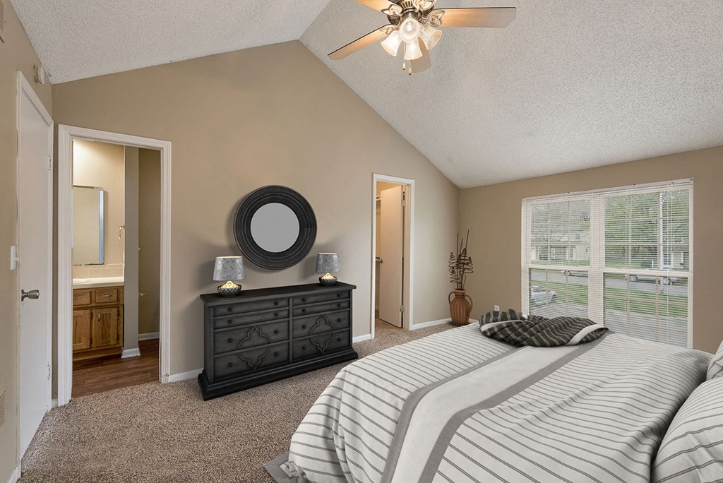 a bedroom with a bed and a ceiling fan