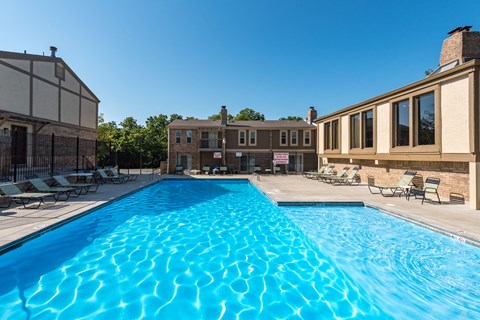 a large swimming pool with a building in the background