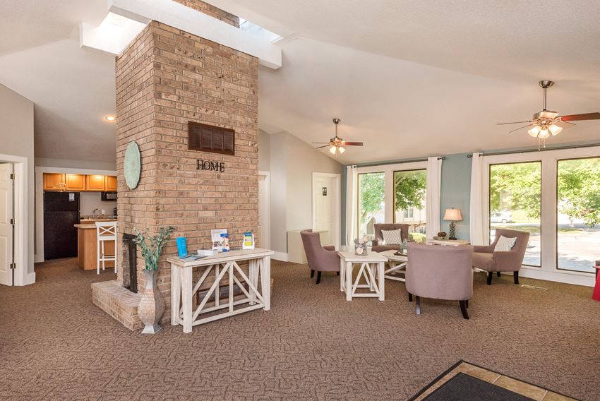 a living room with a fireplace and a dining room with chairs and tables