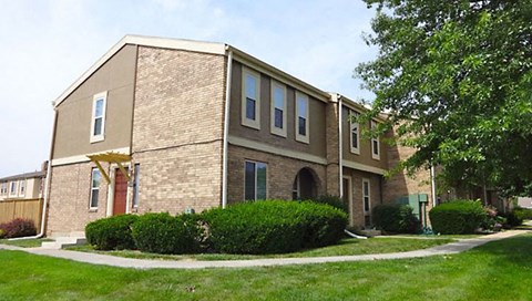 a brick building with a sidewalk in front of it