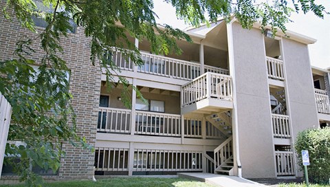 an exterior view of an apartment building with stairs and balconies