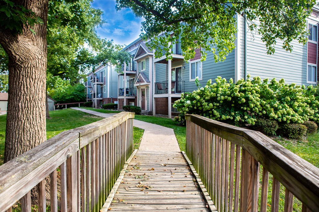 a wooden walkway in front of a row of houses