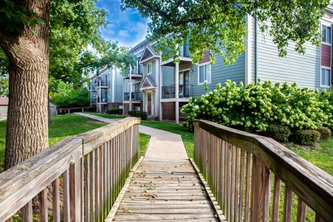 a wooden walkway in front of a row of houses