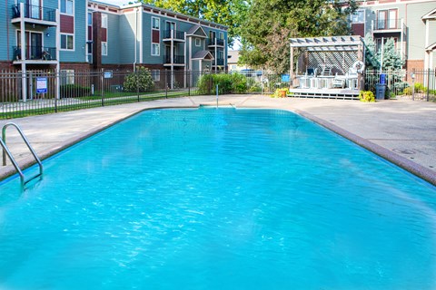 a large swimming pool in front of an apartment building