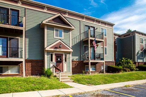 an apartment building with stairs and an flag