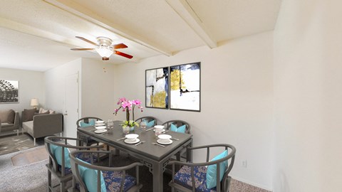 a dining room with a table and chairs and a ceiling fan