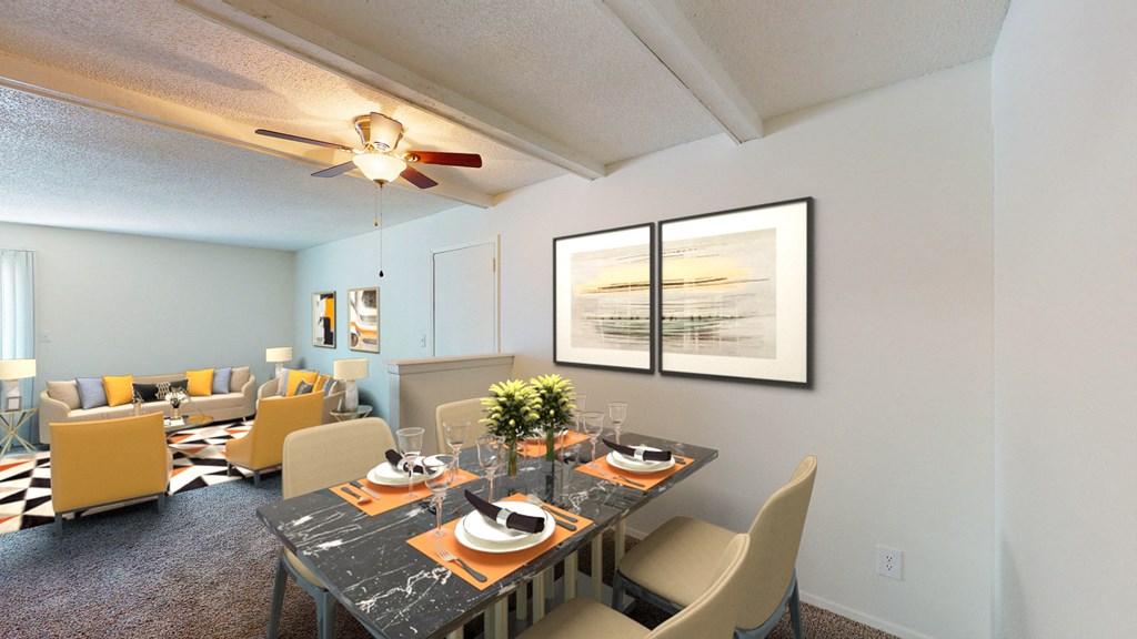 our spacious living room and dining room with a table and chairs and a ceiling fan