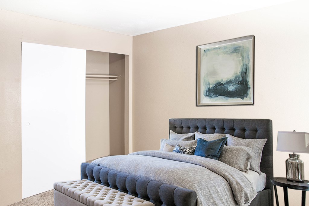 a bedroom with a bed and a large mirror