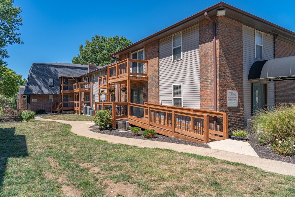 a brick building with a wooden deck on the side of it