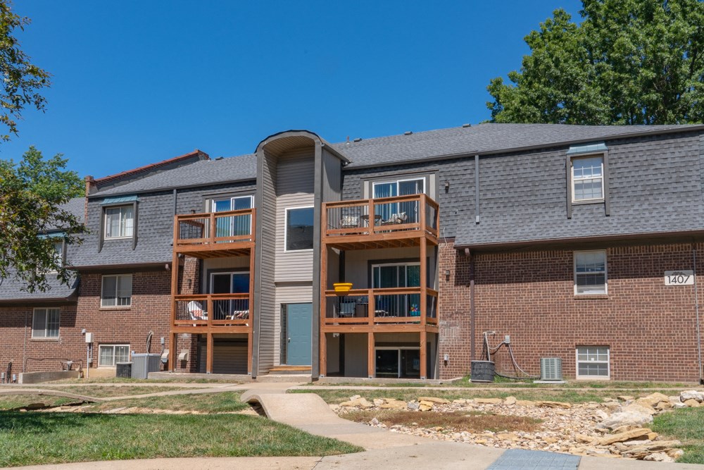 the view of a brick apartment building with balconies