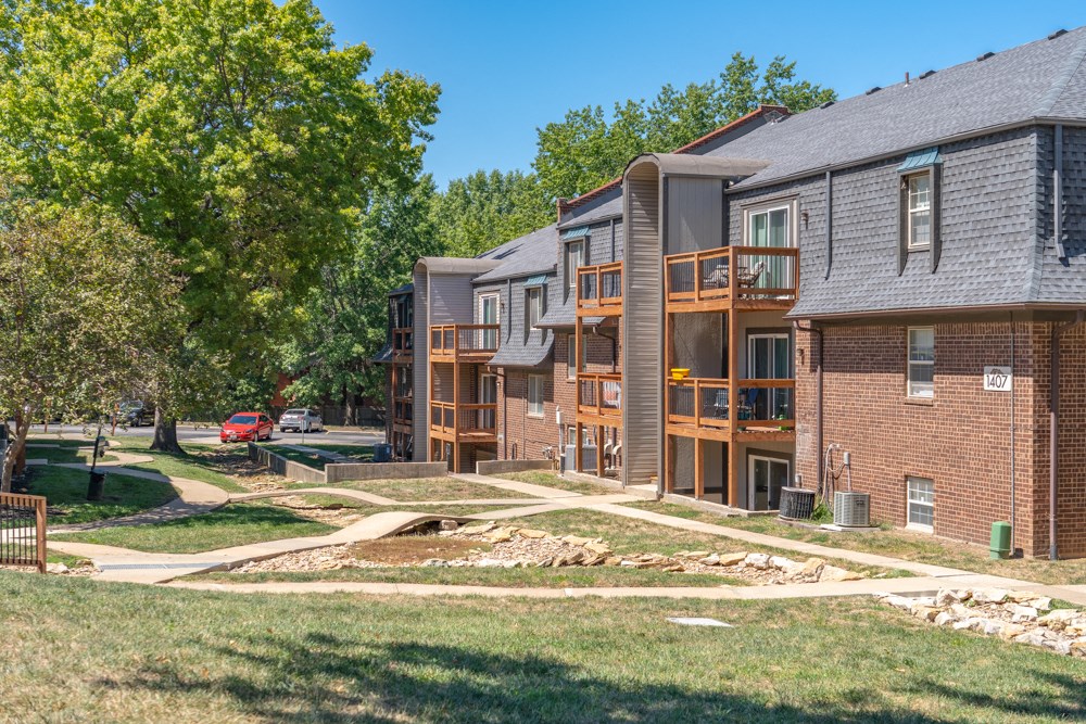 our apartments offer a spacious courtyard with green grass and trees