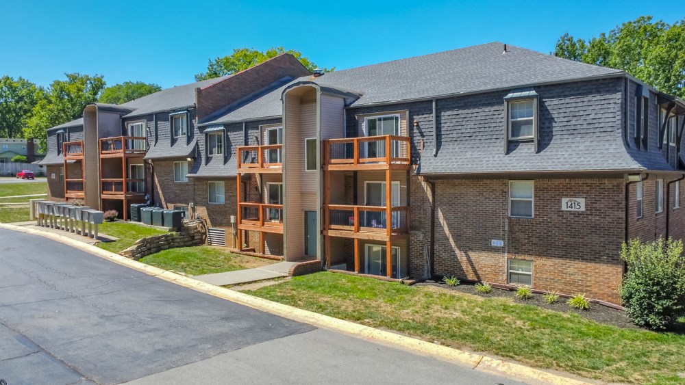 a row of apartment buildings with balconies on the side of a street