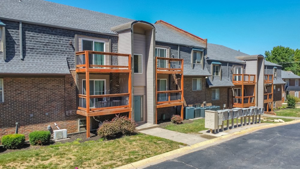 a brick apartment building with wooden balconies