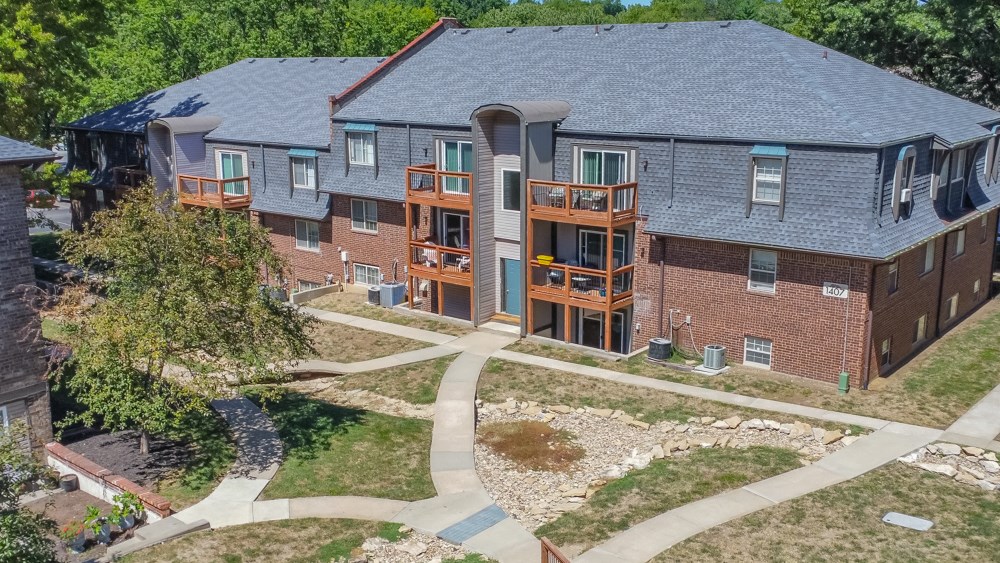 an aerial view of an apartment complex with brick and wood balconies