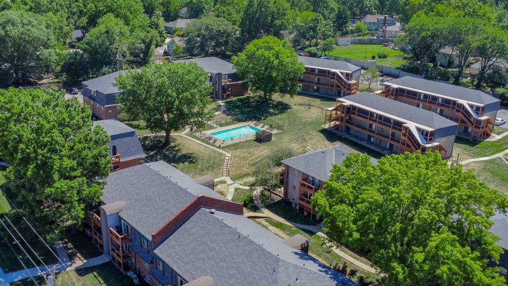 arial view of a neighborhood with buildings and a pool