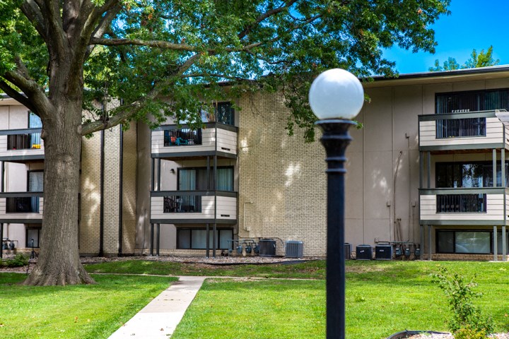 exterior view of a building with a tree and a lamp post