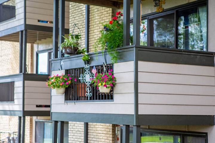 a balcony with pots of flowers on it