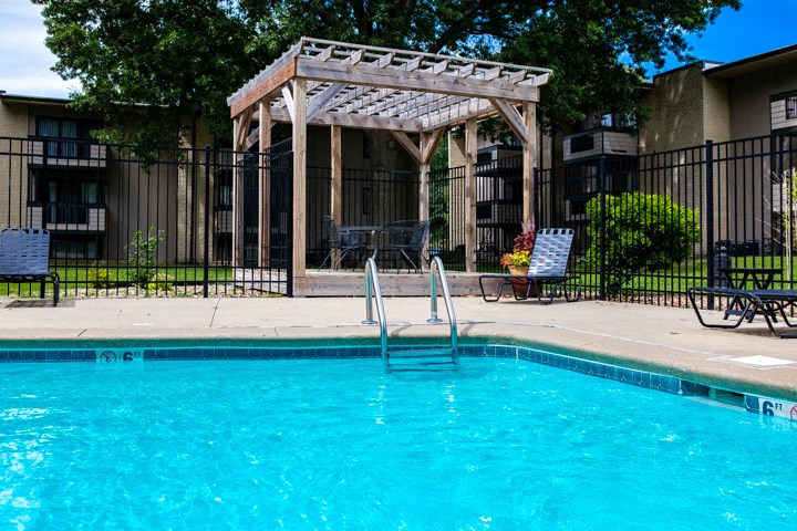 a swimming pool with a gazebo next to a resort style pool