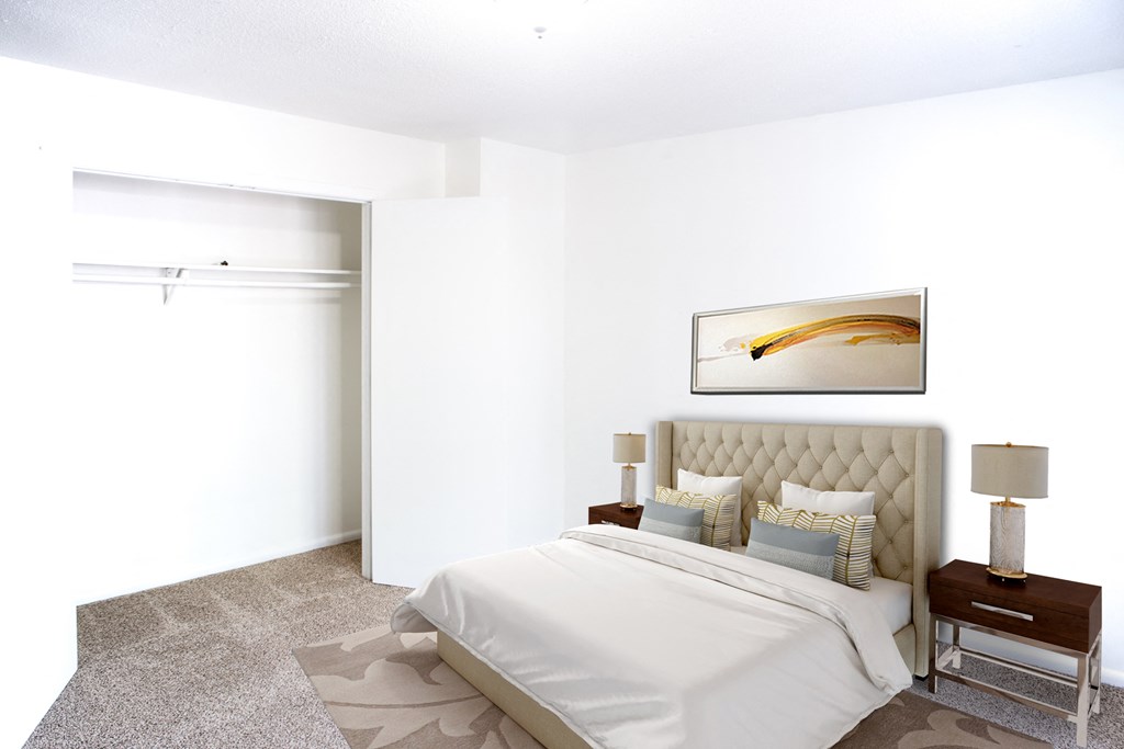 a white bedroom with a bed and a white closet
