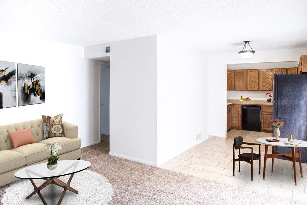 a living room with a couch and a table and a kitchen