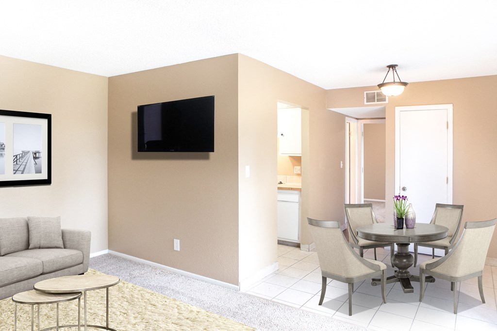 a living room with a table and chairs and a television