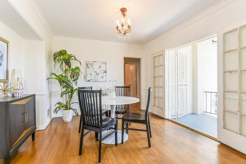 a dining room with a table and chairs and a chandelier