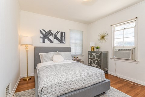 a bedroom with a bed and a window