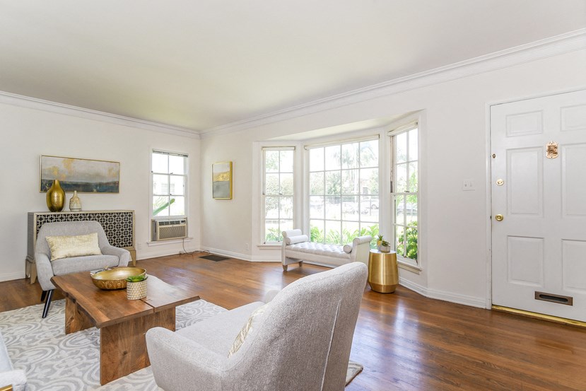 a living room with a couch and chairs and a coffee table