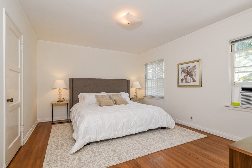 a bedroom with a bed and a rug