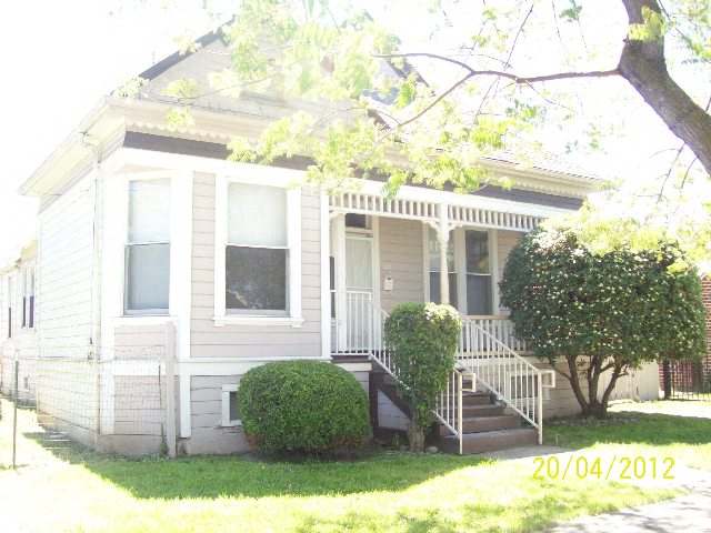 A house with a tree in front of it.