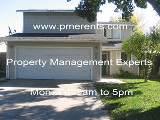 a house with a garage door with the words property management experts on it