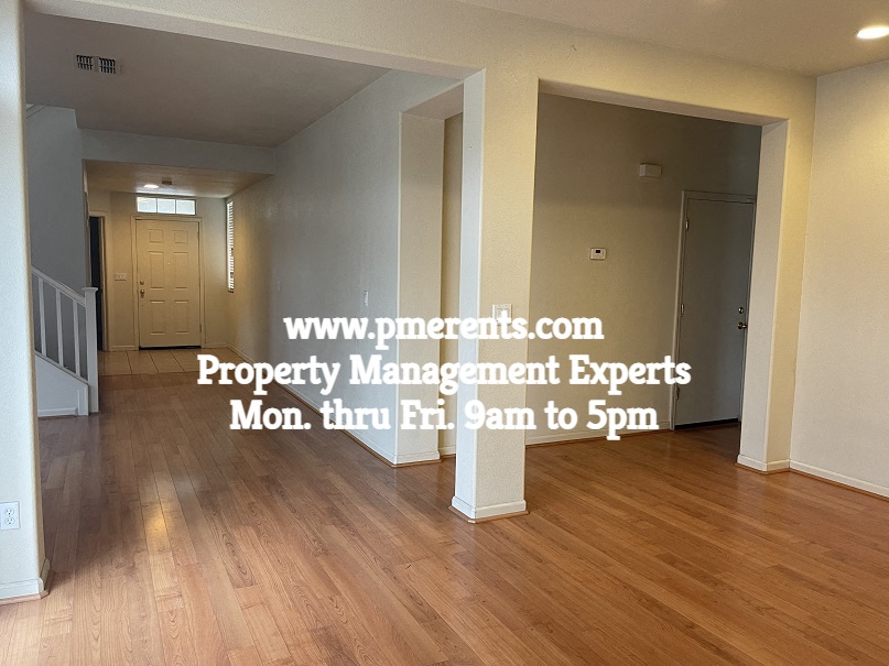 a hypothetical living room and dining room with wood flooring and white walls