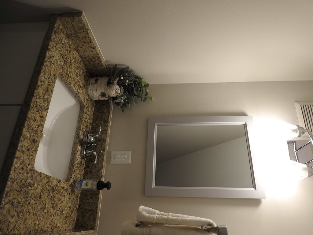 a bathroom with a mirror and a sink