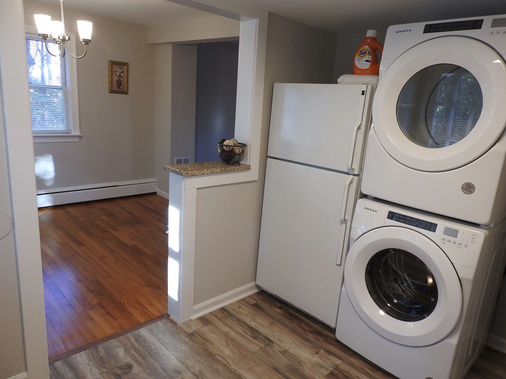 a laundry room with a washing machine and a washer and dryer