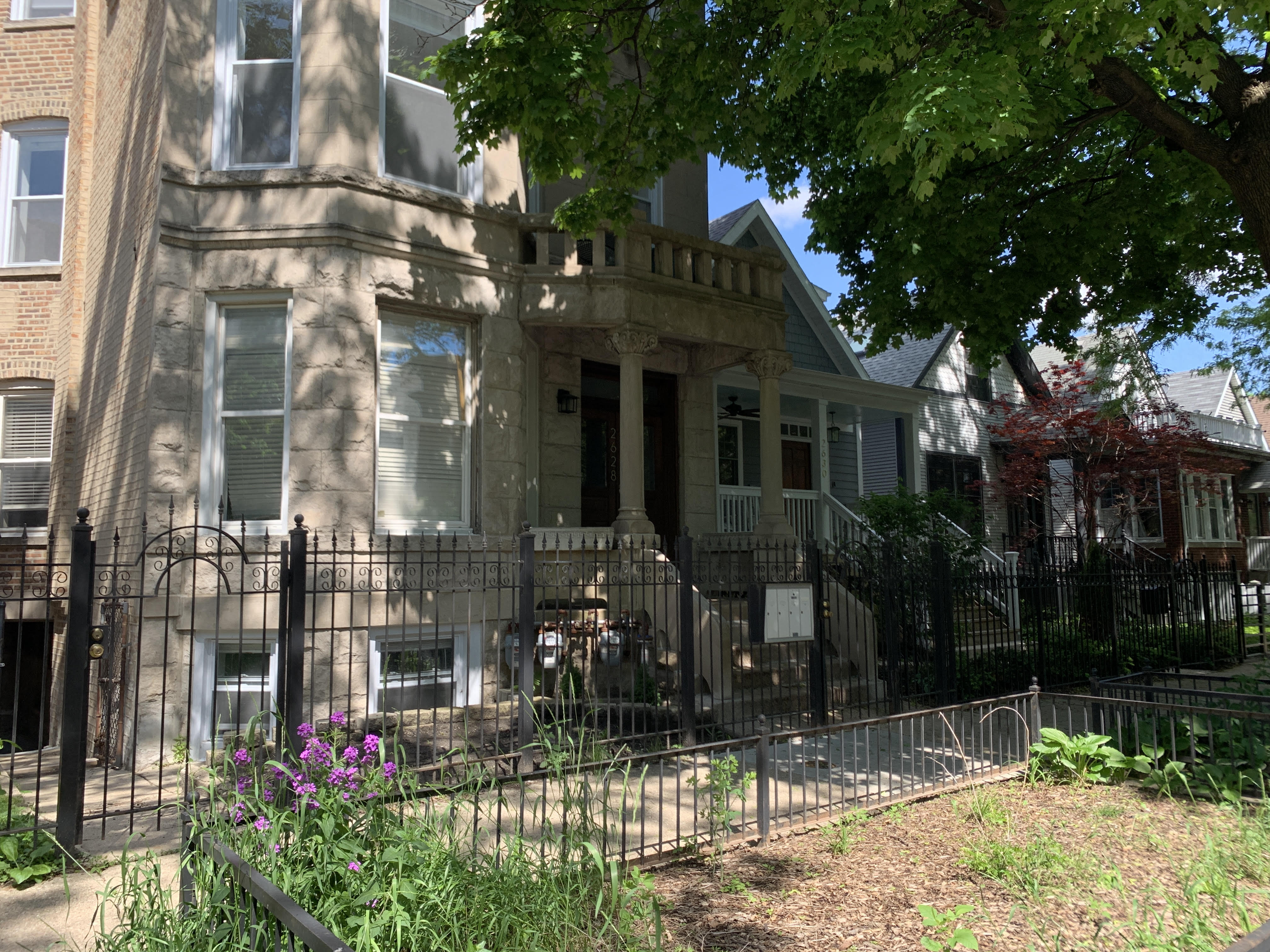 an old house with a fence in front of it