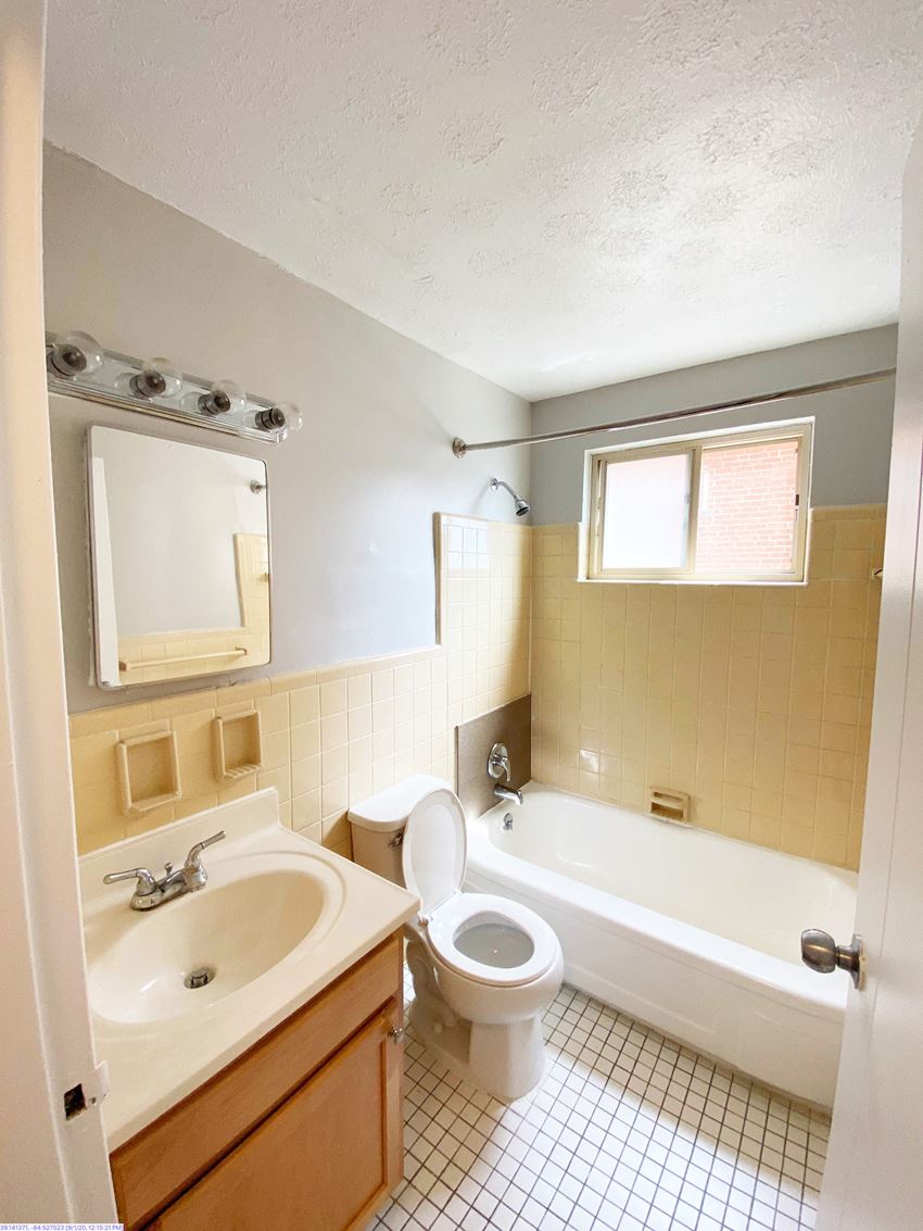 a bathroom with a toilet and a sink and a bath tub