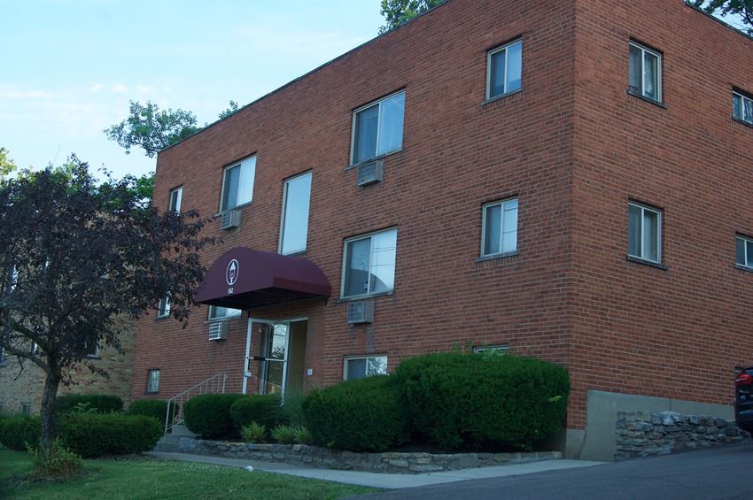 a large brick building with an umbrella in front of it