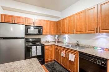 Fully Equipped Kitchen Includes Frost-Free Refrigerator, Electric Range, & Dishwasher at The Preserve at Rock Springs, Rock Springs, 82901