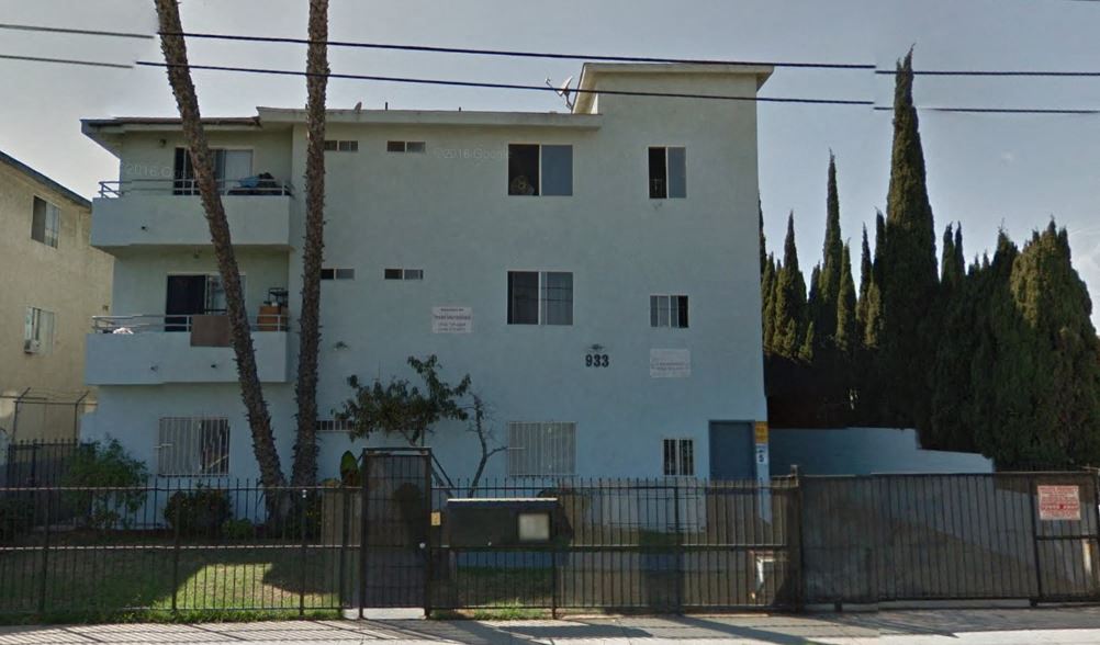a white building with a fence in front of it