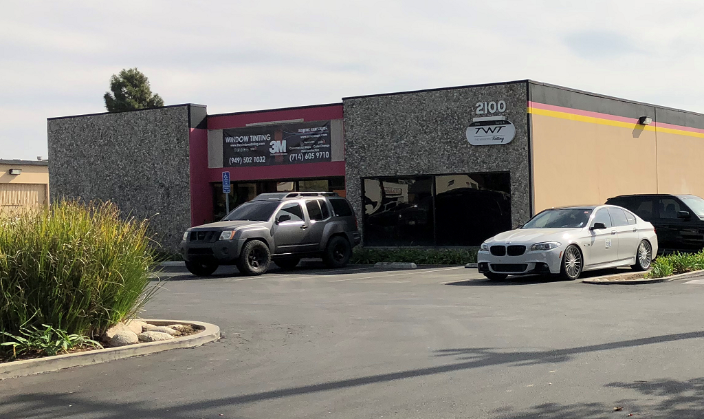 a dealership with cars parked in front of it