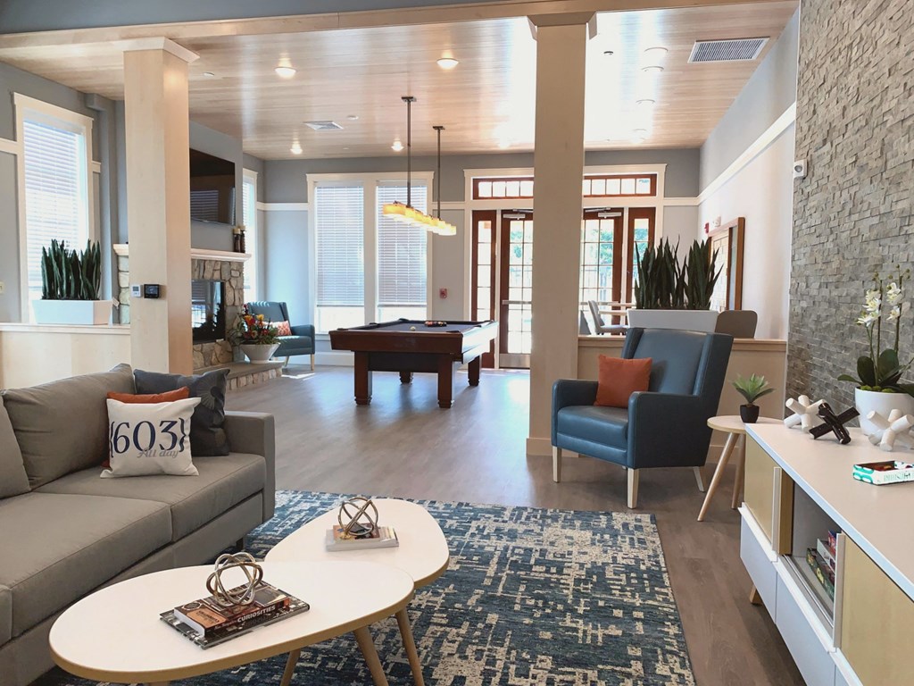 a living room with a pool table and a rug