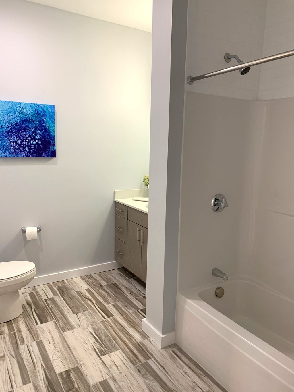 a bathroom with a shower and a toilet and a sink