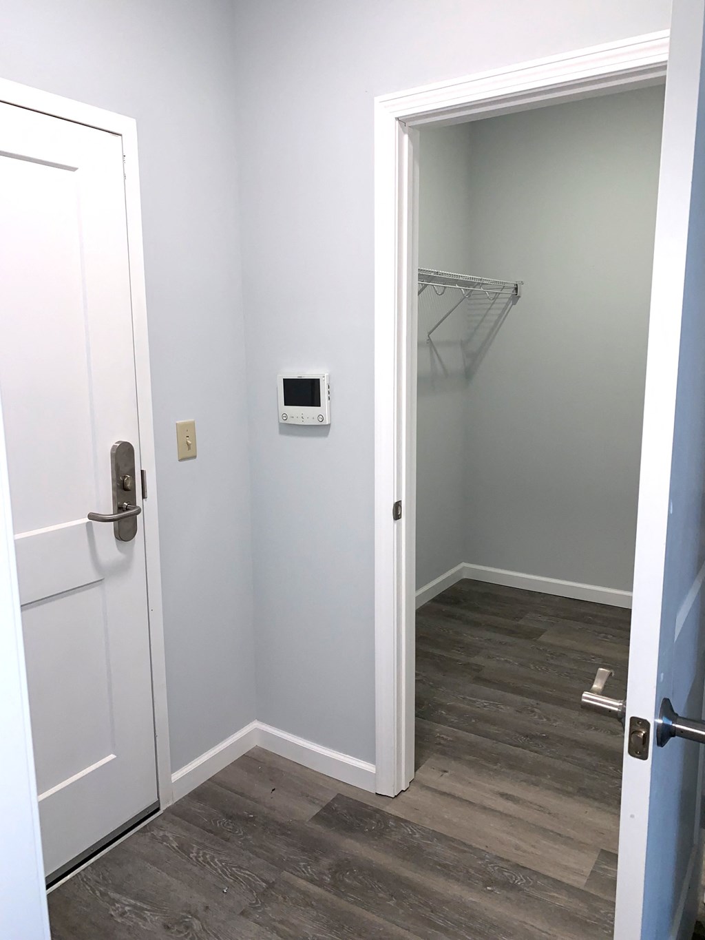 a small room with a door to a closet and a shower