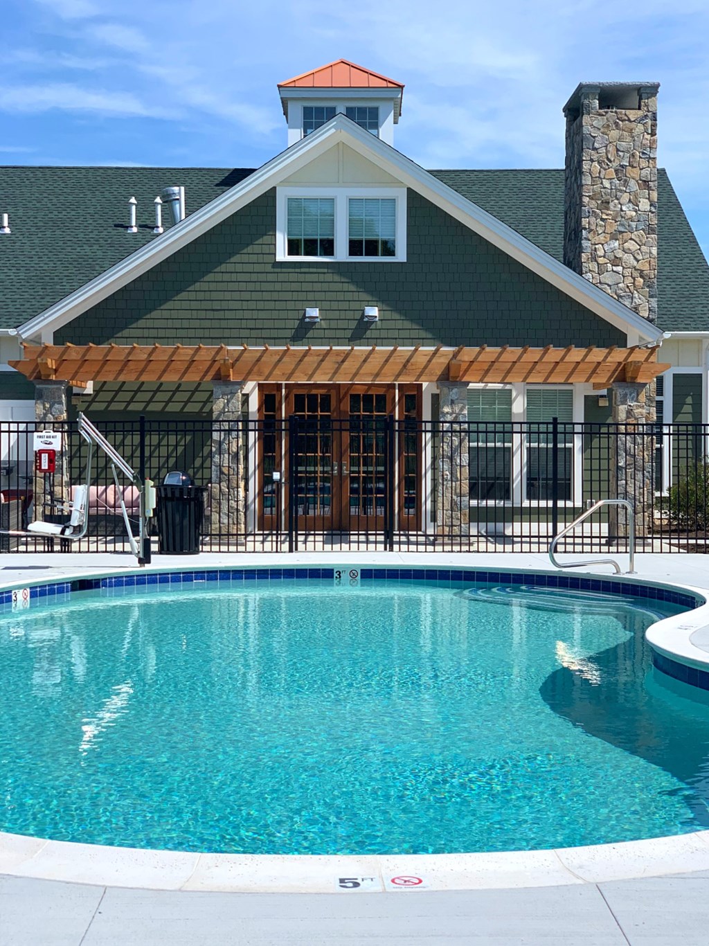 a swimming pool in front of a house with a resort style pool