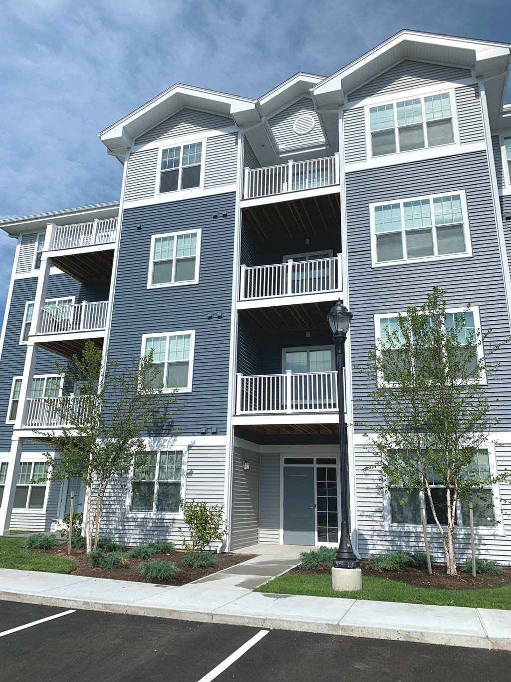 the exterior of an apartment building with stairs and balconies